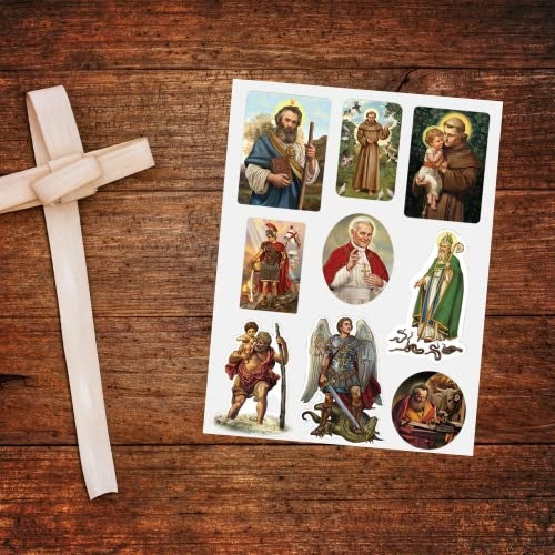 Sheet of Catholic stickers featuring Boy Jesus and various saints on wooden surface beside woven cross