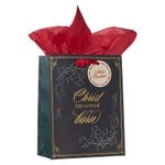 Medium matte black Christmas gift bag with gold foil double frame and "Christ is Born" script, red tissue paper inside