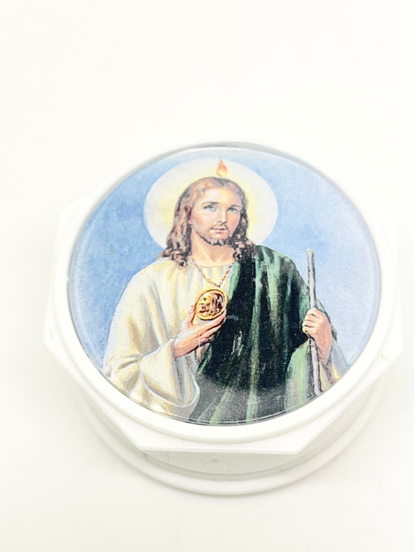 Round white rosary case with detailed image of St. Jude holding a medallion and staff against blue background