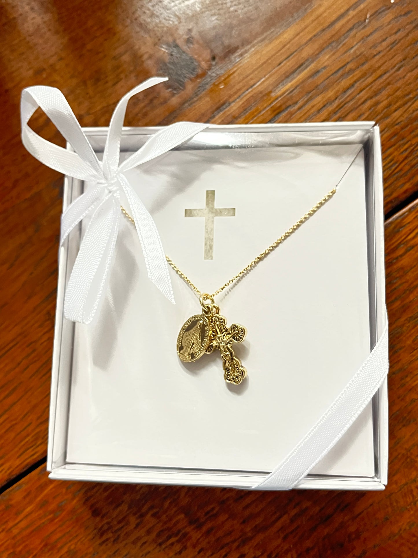 15-inch gold necklace featuring a Miraculous Medal and detailed crucifix on delicate chain in white gift box