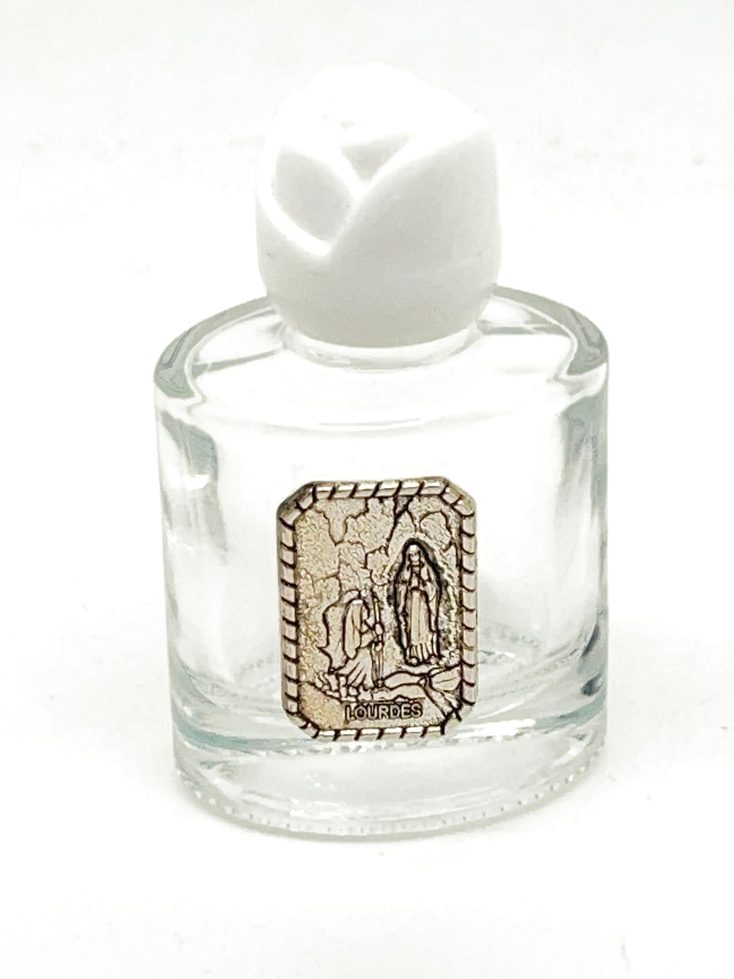 Clear glass holy water bottle 2.25 inches tall with Our Lady of Lourdes silver-tone emblem and white rose cap.