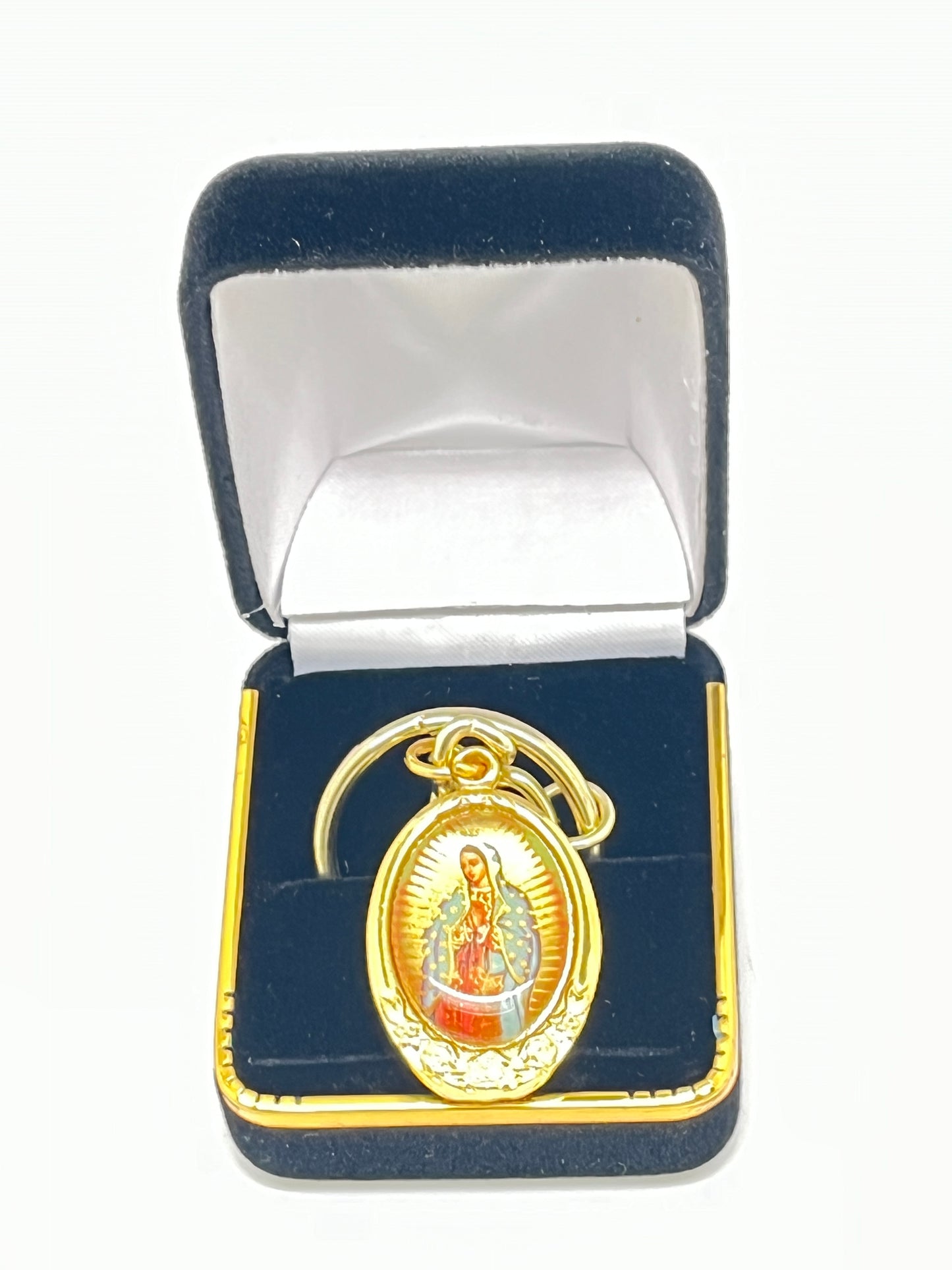 Gold key chain with image of Our Lady of Guadalupe and St. Juan Diego inside a black velvet gift box
