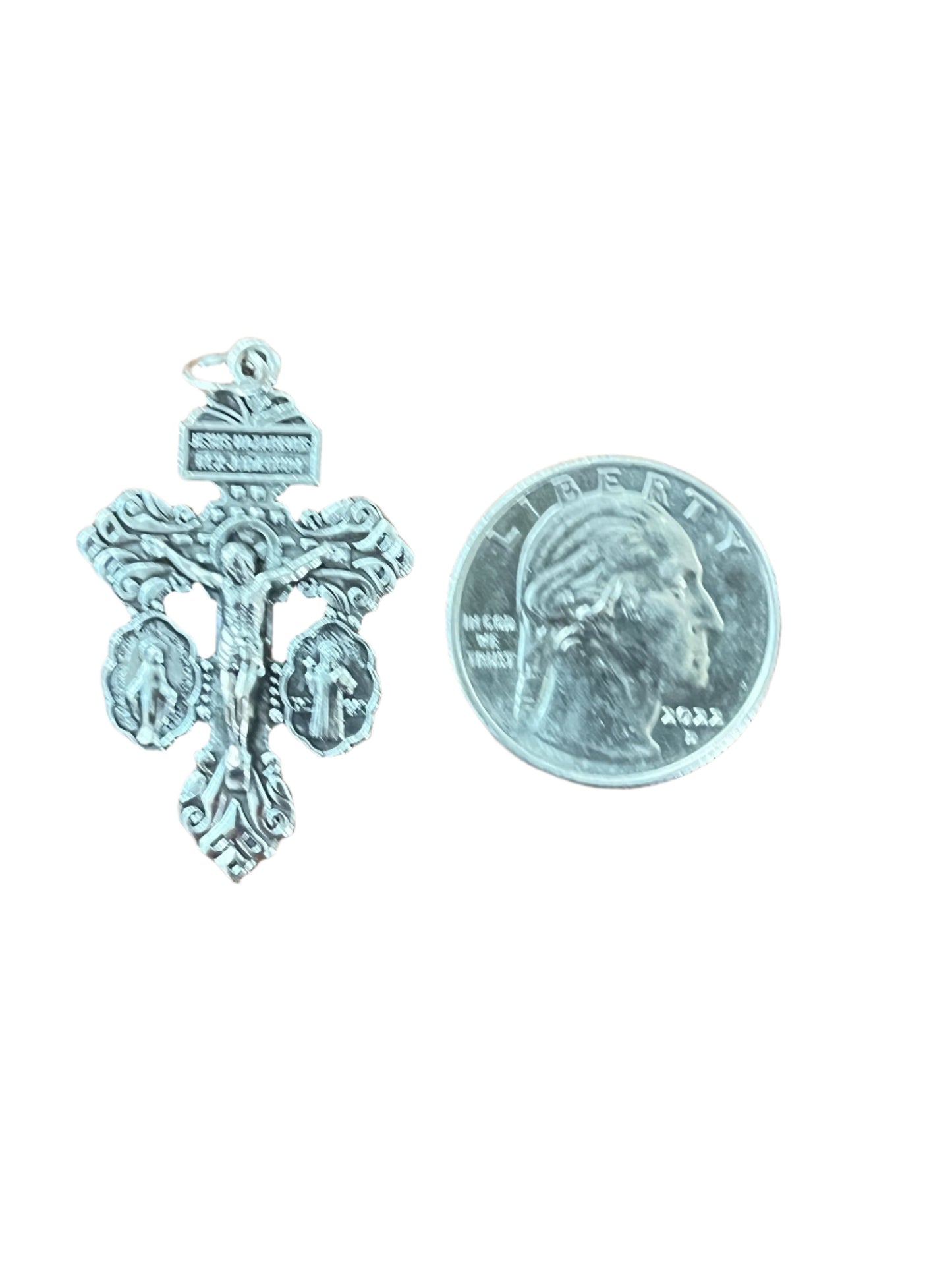 3-way pardon indulgence crucifix with Benedict and Miraculous medals, detailed silver rosary pendant next to quarter coin for size.