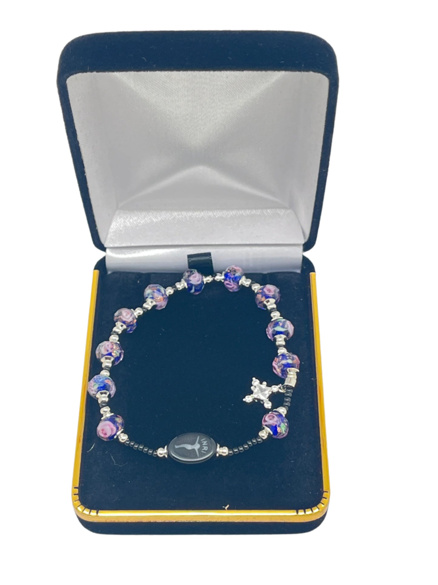 Blue Swirl Murano Glass Rosary Bracelet with faceted beads and silver crucifix, displayed in navy velvet gift box.