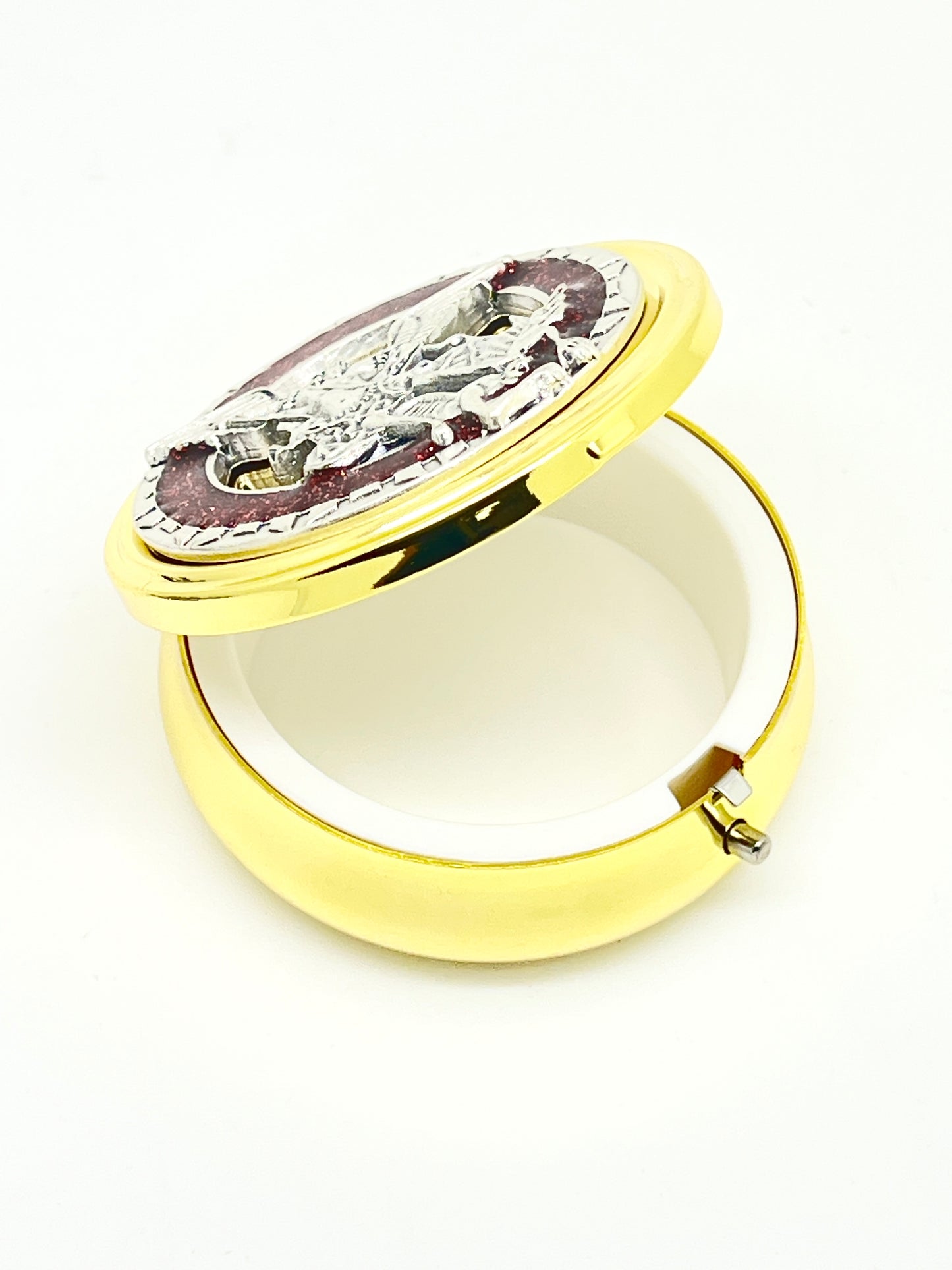 2 1/8" gold pyx with pewter St. Michael medallion, red enamel accents, and white plastic lining inside