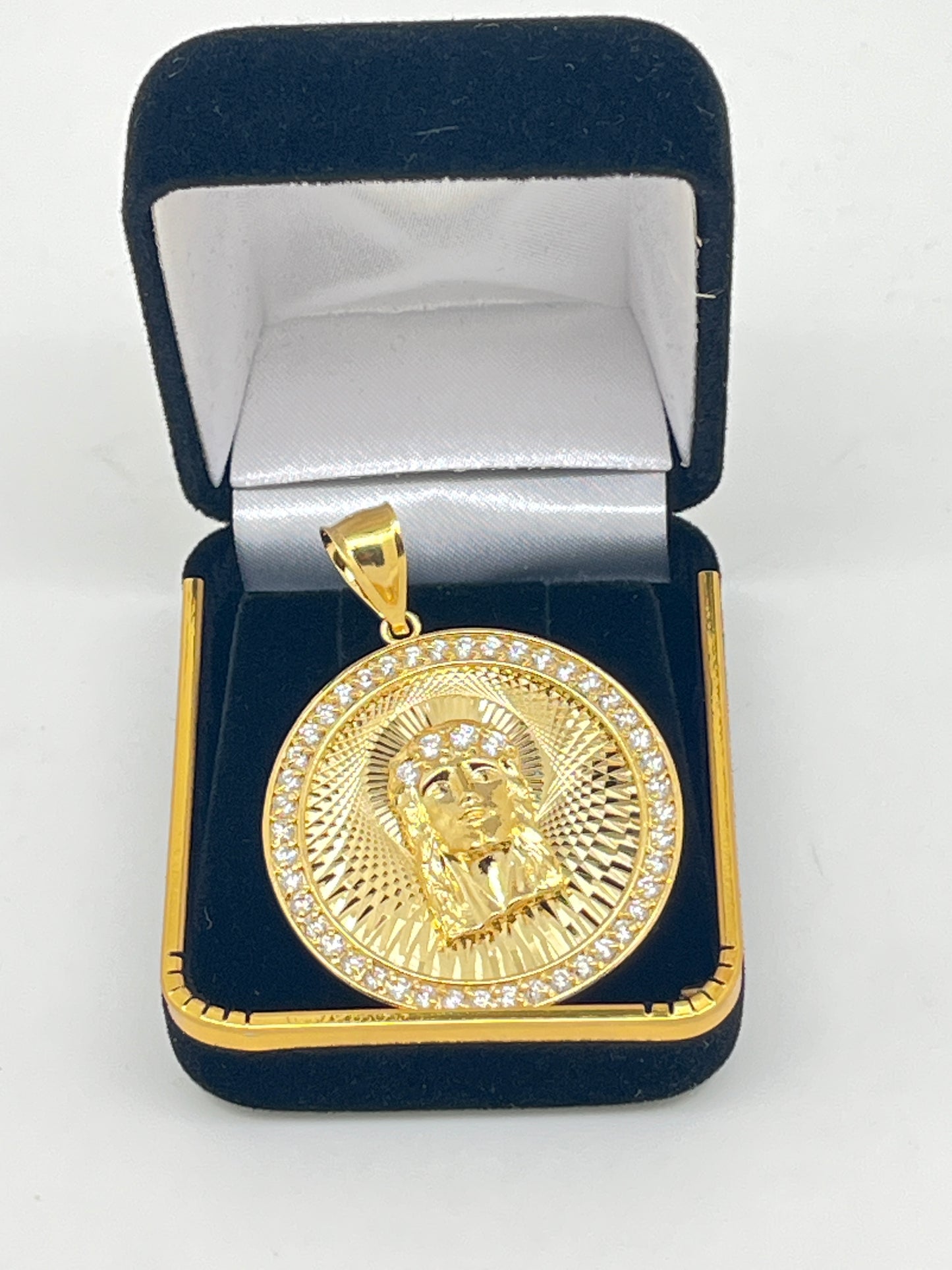 1 3/8" gold plated brass pendant of Holy Face of Jesus with rhinestone border in black and gold jewelry box