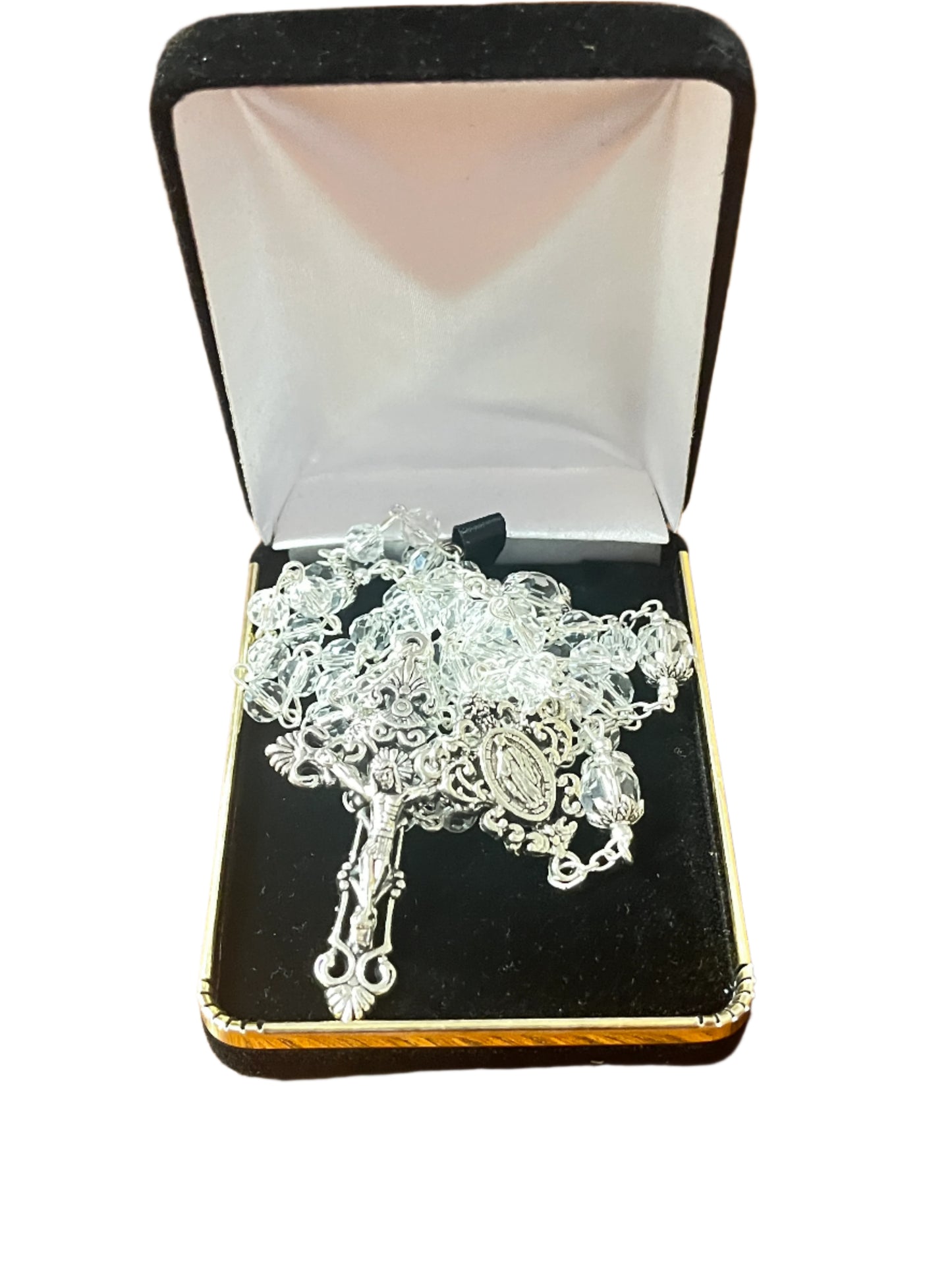 Clear crystal Our Lady of Grace rosary with silver crucifix and centerpiece, displayed in black velvet box