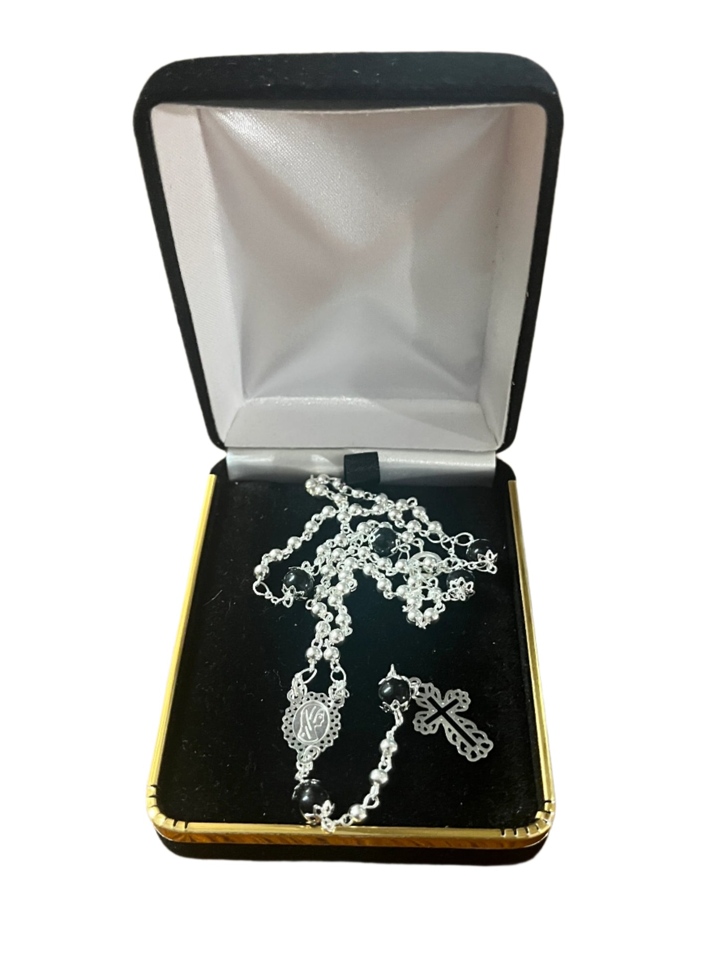 Silver and black 3mm rosary necklace with silver cross and centerpiece displayed inside black and gold jewelry box