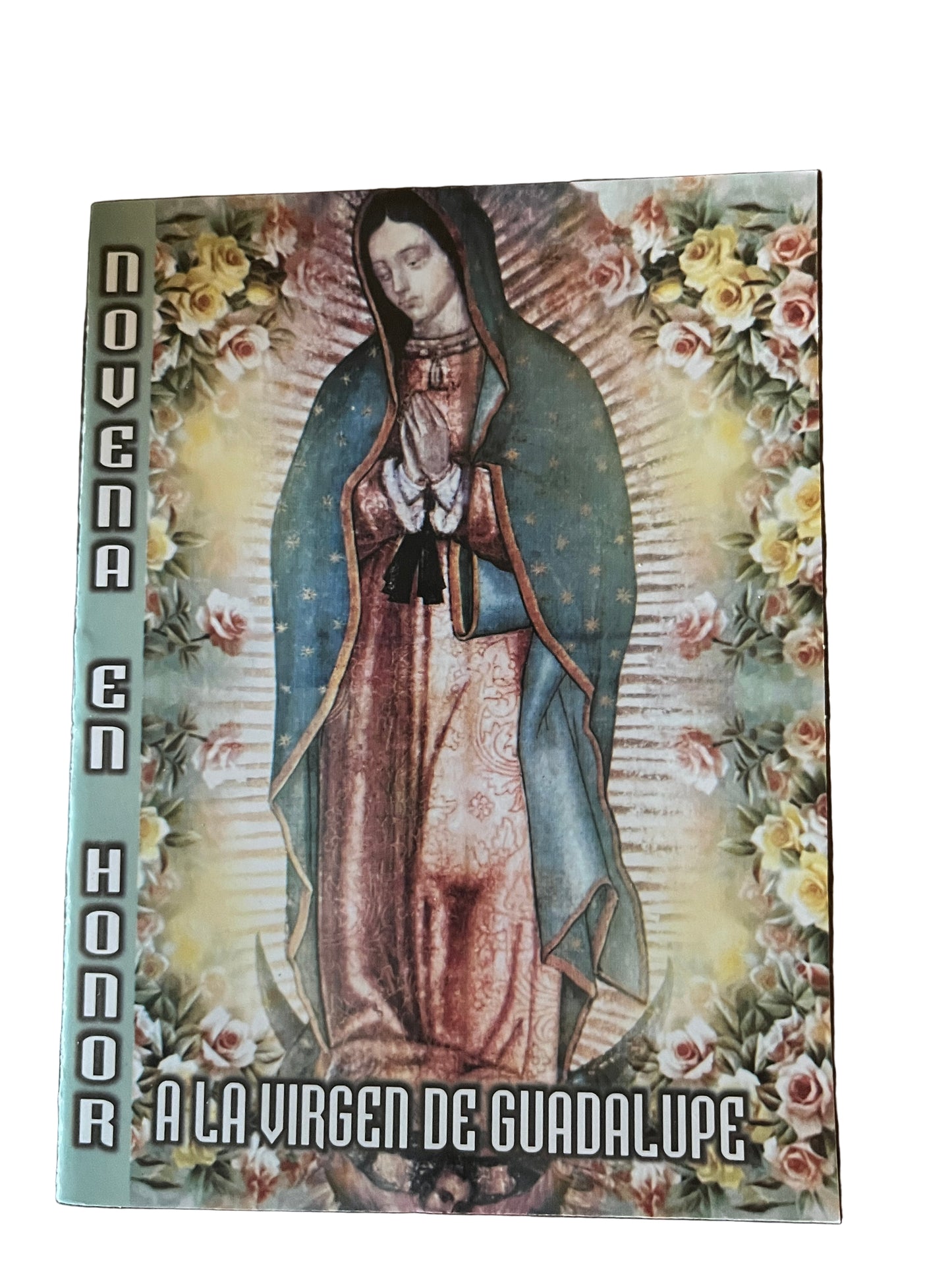 Prayer booklet titled Novena en Honor a la Virgen de Guadalupe with image of Virgin Mary surrounded by roses