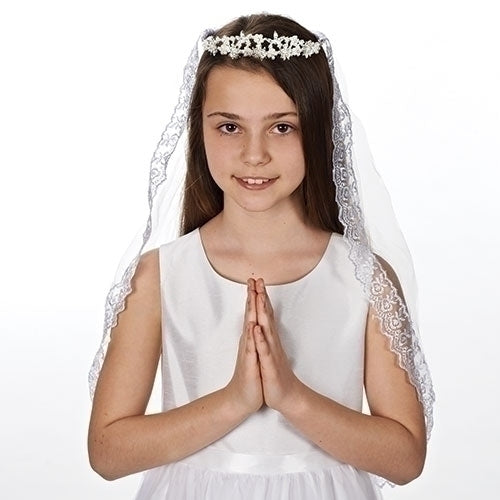 Young girl in white First Communion dress wearing Kate Pearl Tiara with lace-trimmed veil, hands folded in prayer