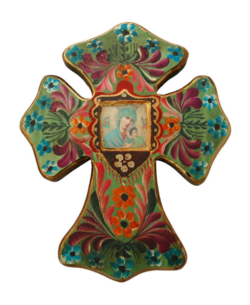Mexican hand-painted cross with vibrant folk art floral designs and central image of Madonna and child on wood background