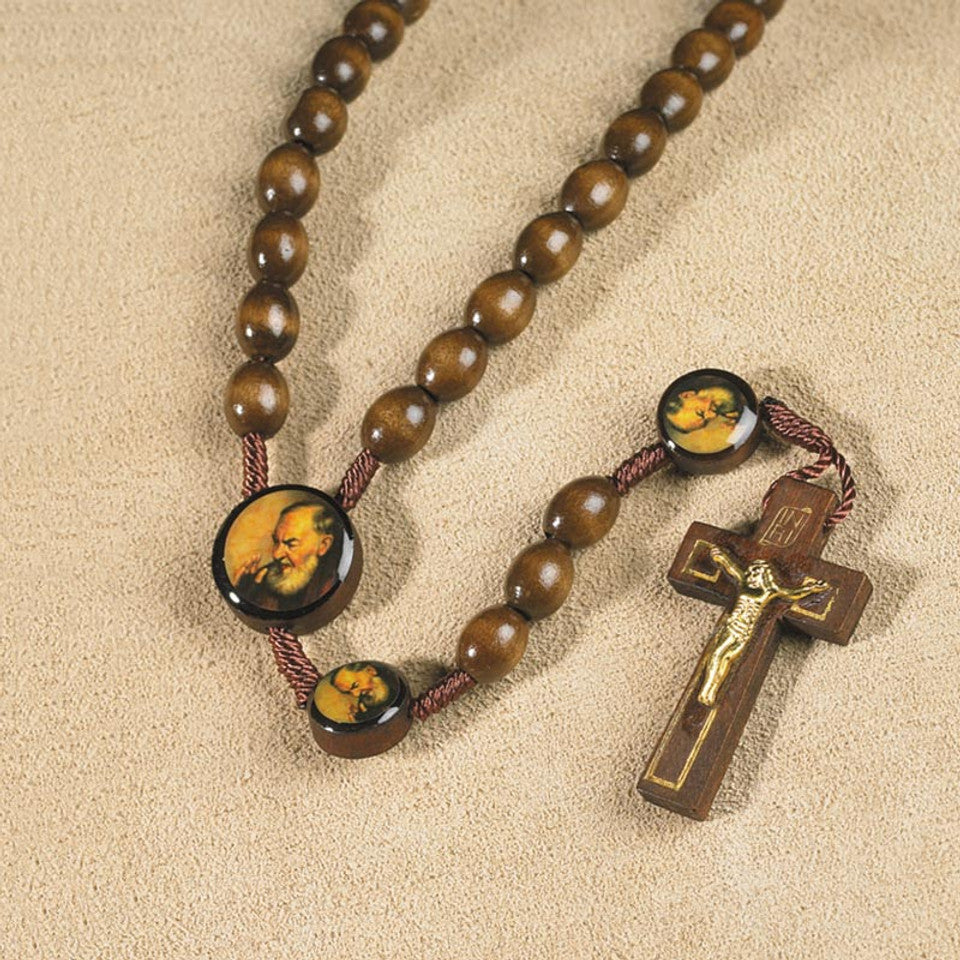 Padre Pio wood rosary with round image beads and brown crucifix with gold-tone corpus on beige background