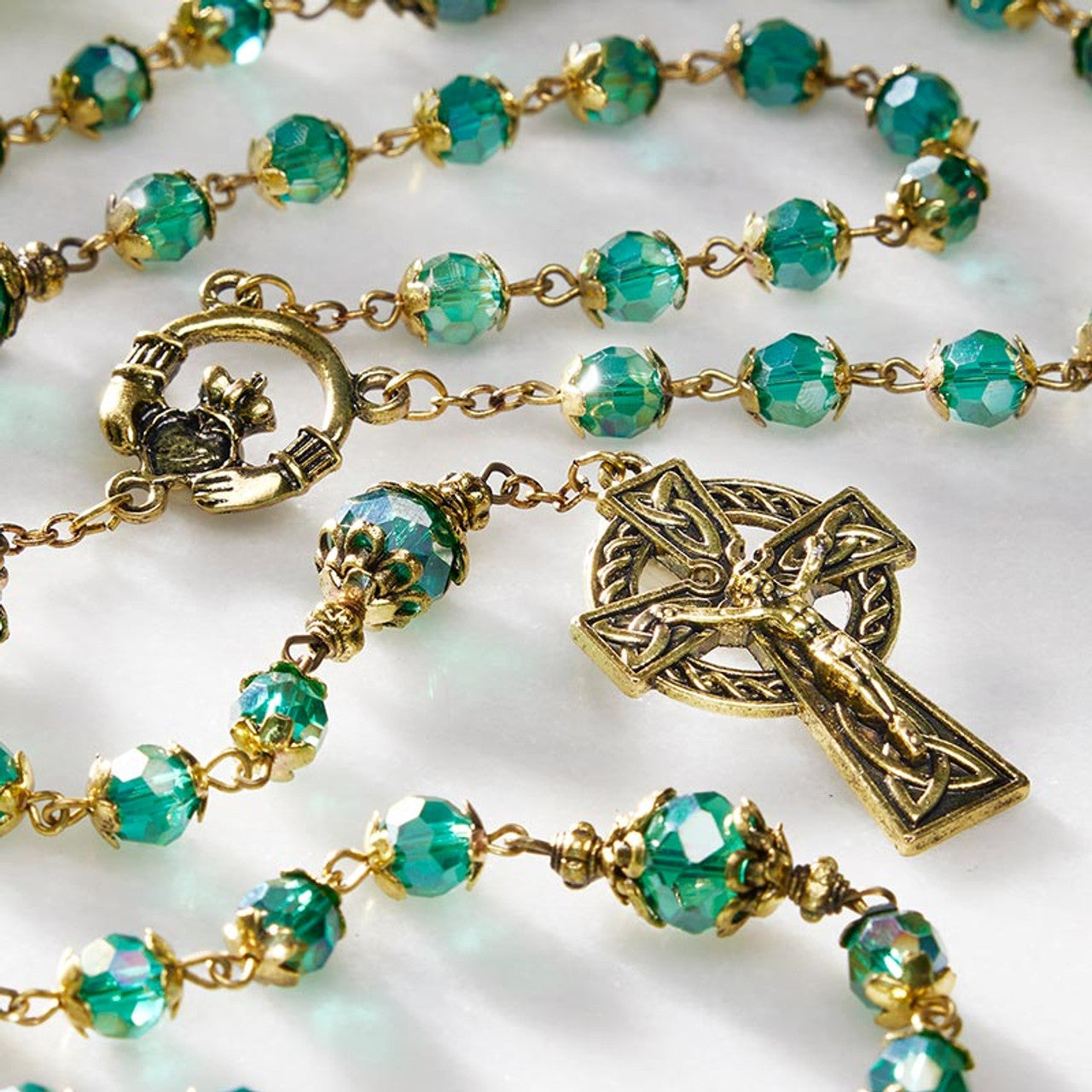 Saint Patricks rosary with emerald Aurora Borealis crystal beads, gold-tone Claddagh centerpiece, and Celtic crucifix pendant
