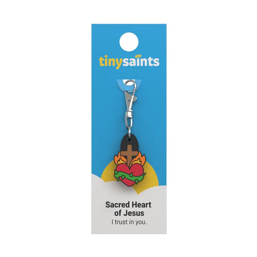 Sacred Heart of Jesus Tiny Saint keychain with heart, flames, crown of thorns, and cross on blue and white card packaging