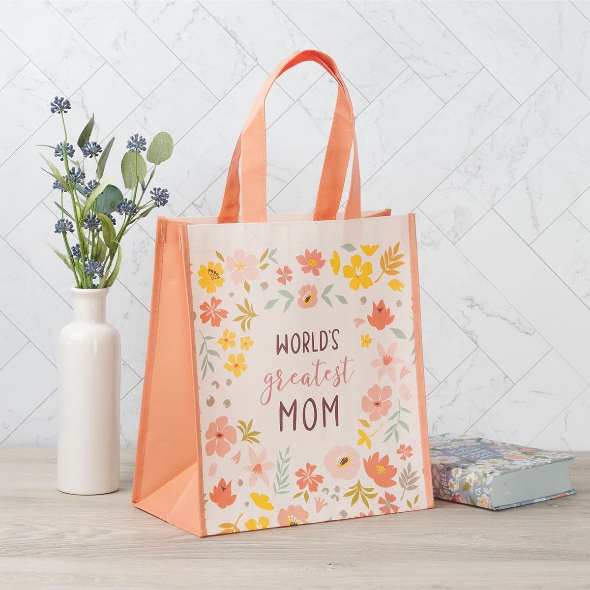 World's Greatest Mom non-woven coated tote bag with peach sides and colorful floral design on front panel
