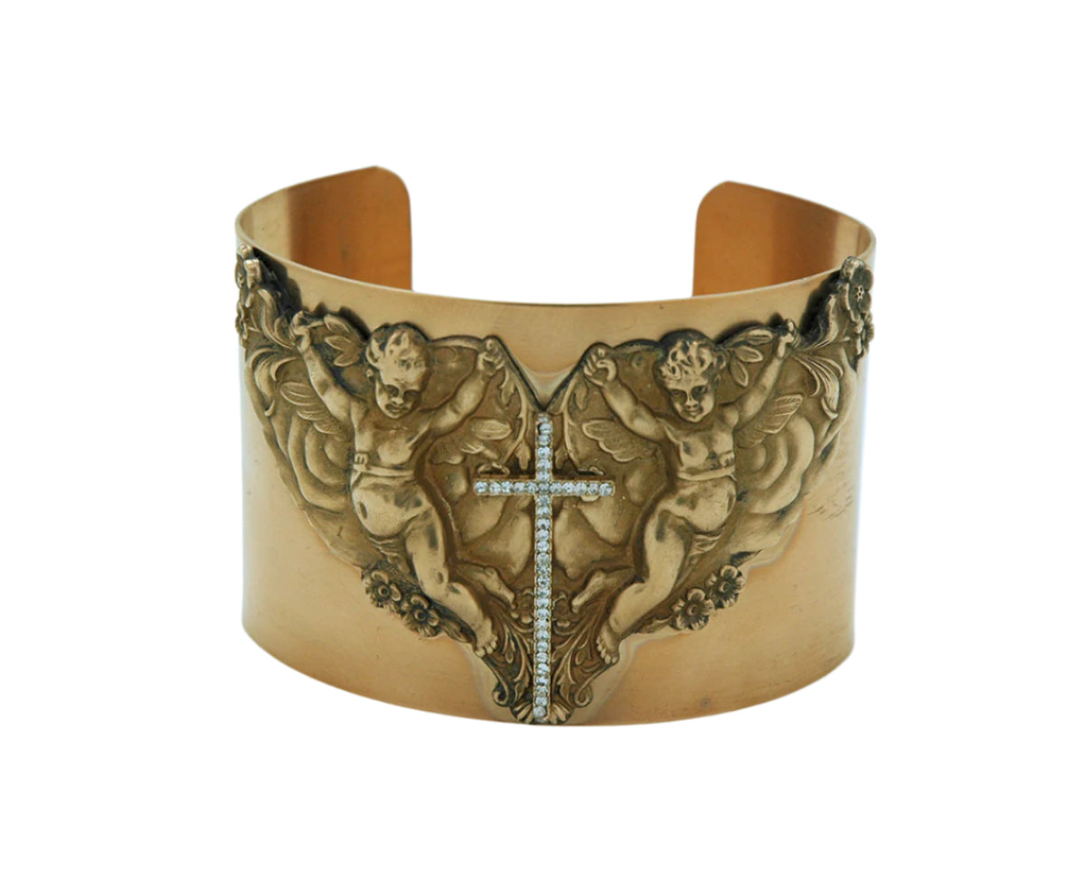 Vintage-style cuff bracelet with detailed angel motifs and Swarovski crystal cross centerpiece in antique gold finish