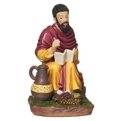 3-inch St. Matthew the Evangelist statue seated reading book with traditional robes, clay jug, and basket of fruit on base.