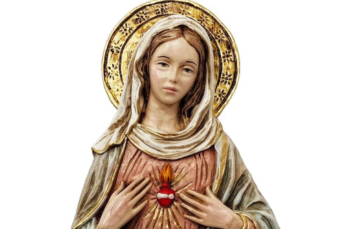 Detailed religious statue of Virgin Mary with gold halo, heart emblem, and soft pastel robe colors on white background