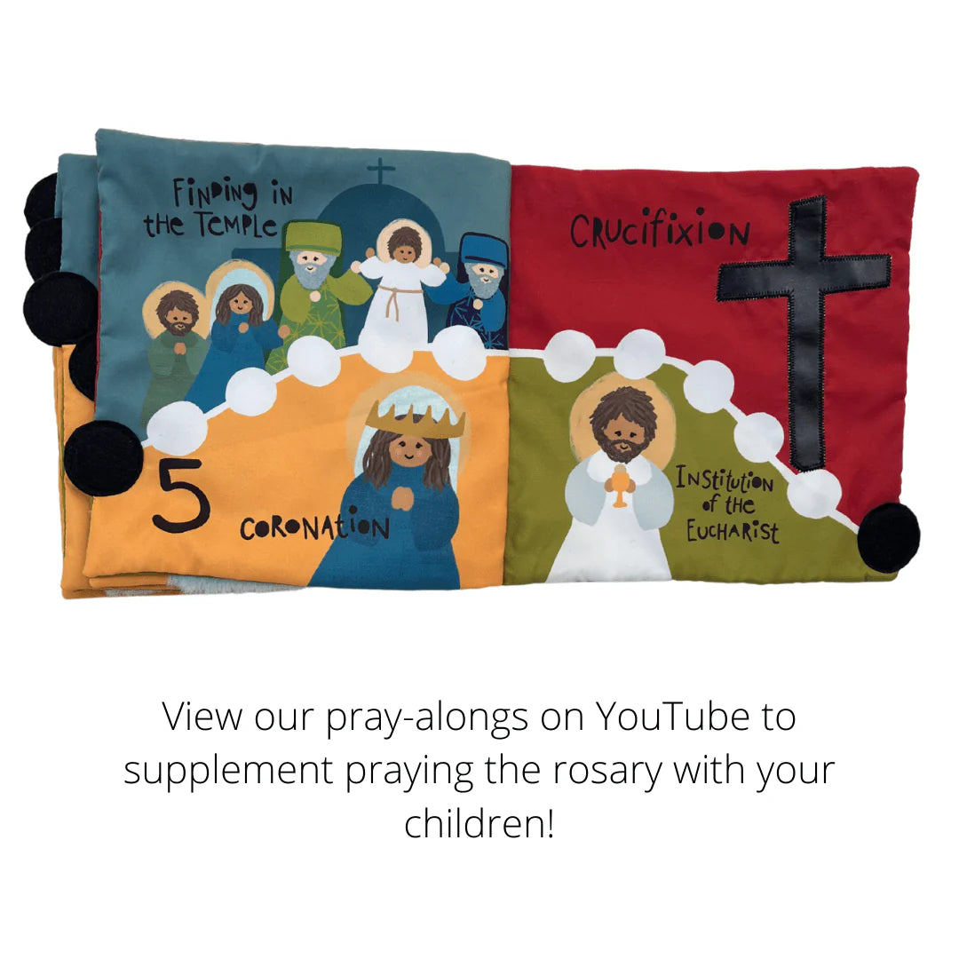 Rosary Mass quiet book open to colorful fabric pages depicting crucifixion, coronation, and rosary mysteries for children