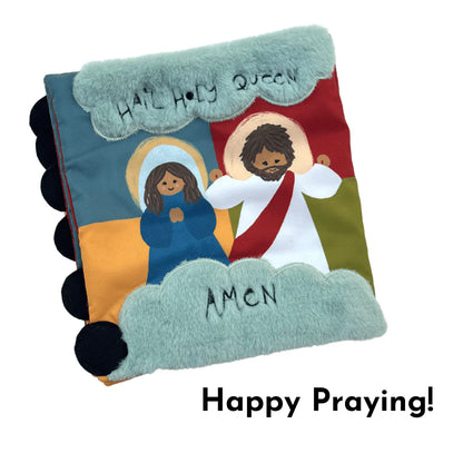 Soft fabric Rosary Mass Quiet Book cover featuring Mary and Jesus with "Hail Holy Queen" and "Amen" text in clouds