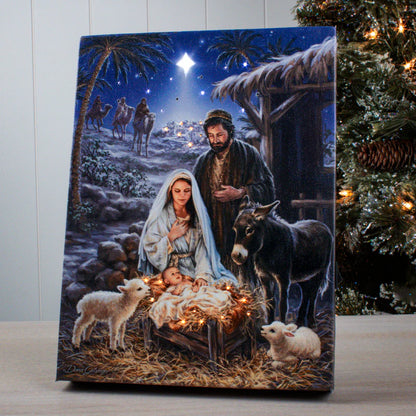 A Savior is Born" 8x6 lighted tabletop canvas featuring nativity scene with Mary, Joseph, baby Jesus, animals, and shining star