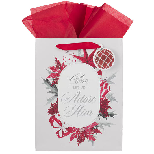 White gift bag with red poinsettias, wrapped presents, red tissue paper, and "Oh come, let us adore Him" text in script font