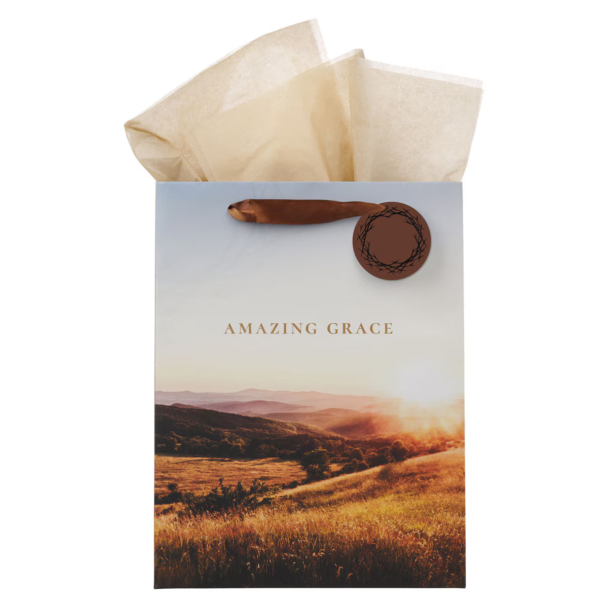 Large portrait gift bag with sunrise landscape, "Amazing Grace" text, and crown of thorns tag with brown handle and tissue paper