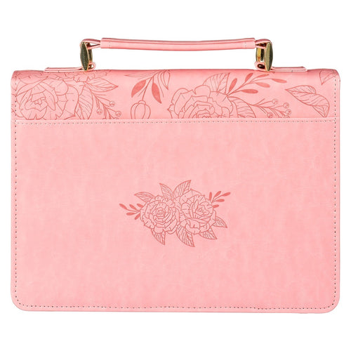 Large pink faux leather Bible cover with embossed rose floral design and sturdy top handle for easy carrying