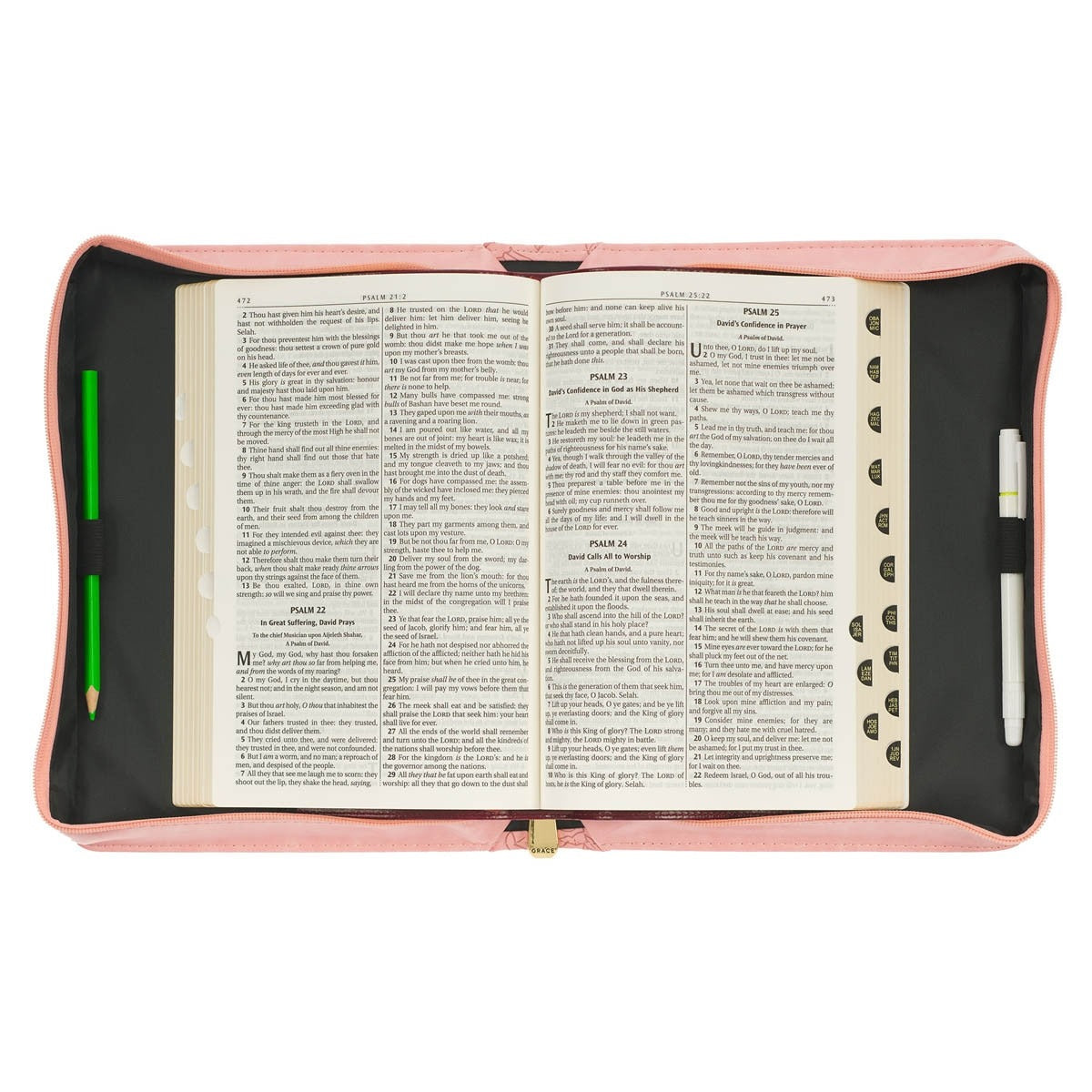 Open rose pink faux leather Bible cover with pen holder and gold zipper, displaying open Bible inside
