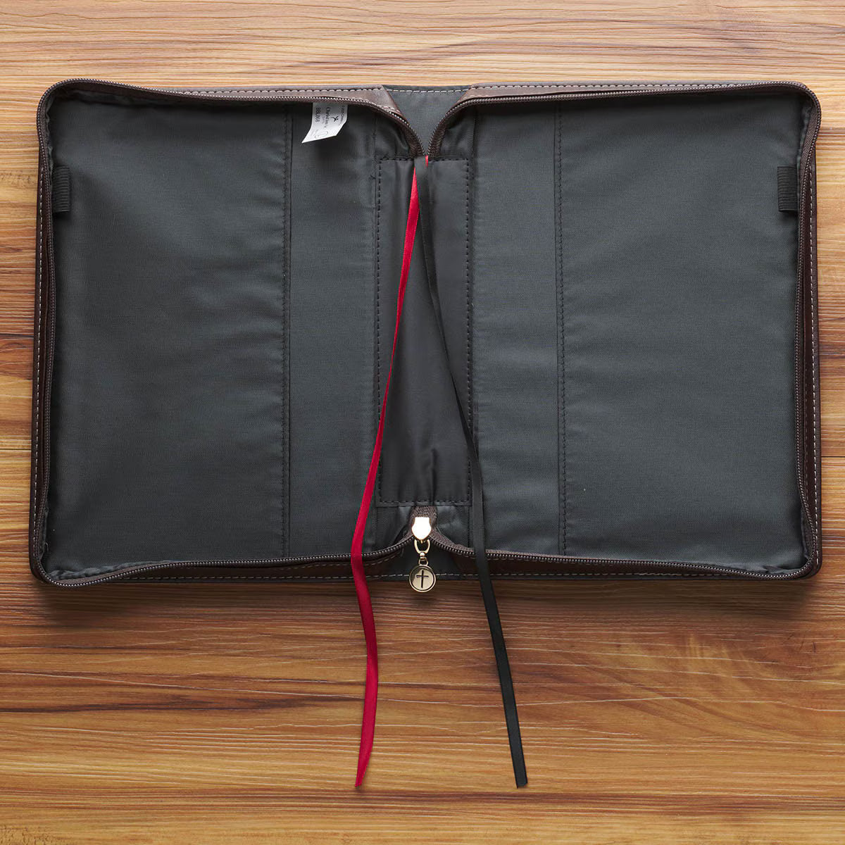 Inside view of blush floral faux leather Bible cover with black interior, red and black ribbon bookmarks, and zipper pocket