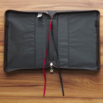 Inside view of blush floral faux leather Bible cover with black interior, red and black ribbon bookmarks, and zipper pocket