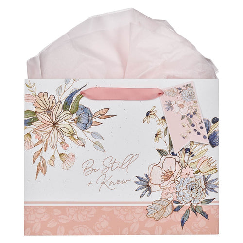 Large landscape gift bag with peach blossom floral design, scripture "Be Still and Know", and pink ribbon handles