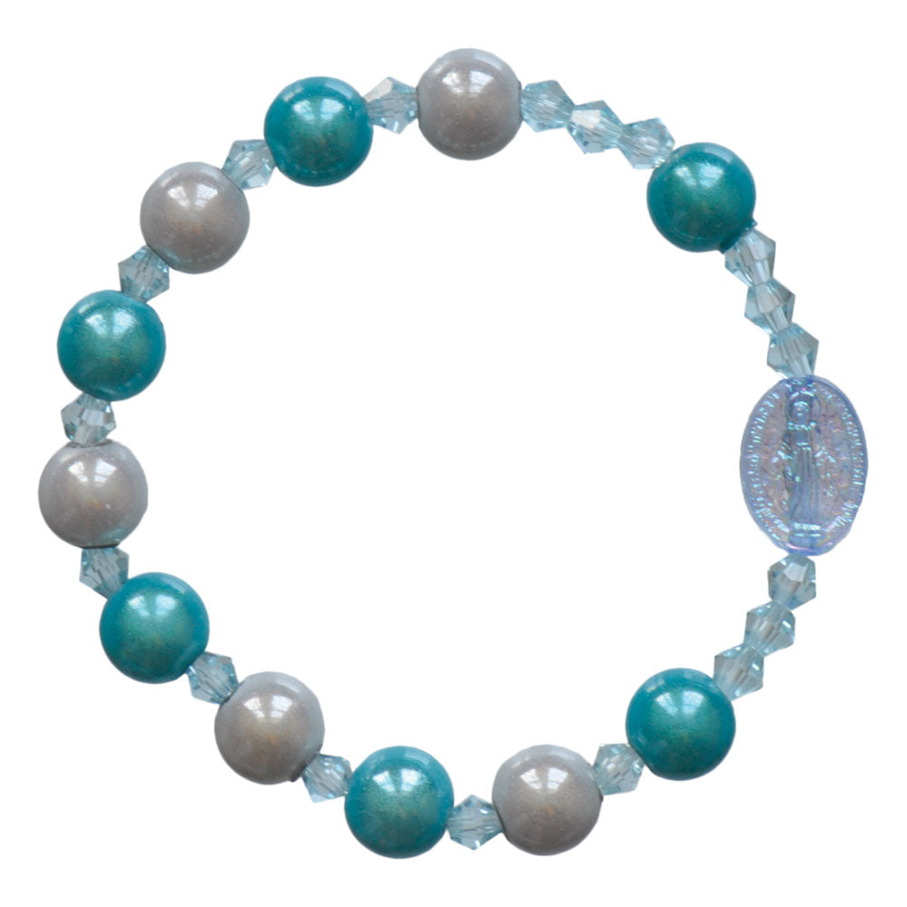 Children's rosary bracelet with aqua and pearl-like beads, featuring a clear oval centerpiece medal of Mary.