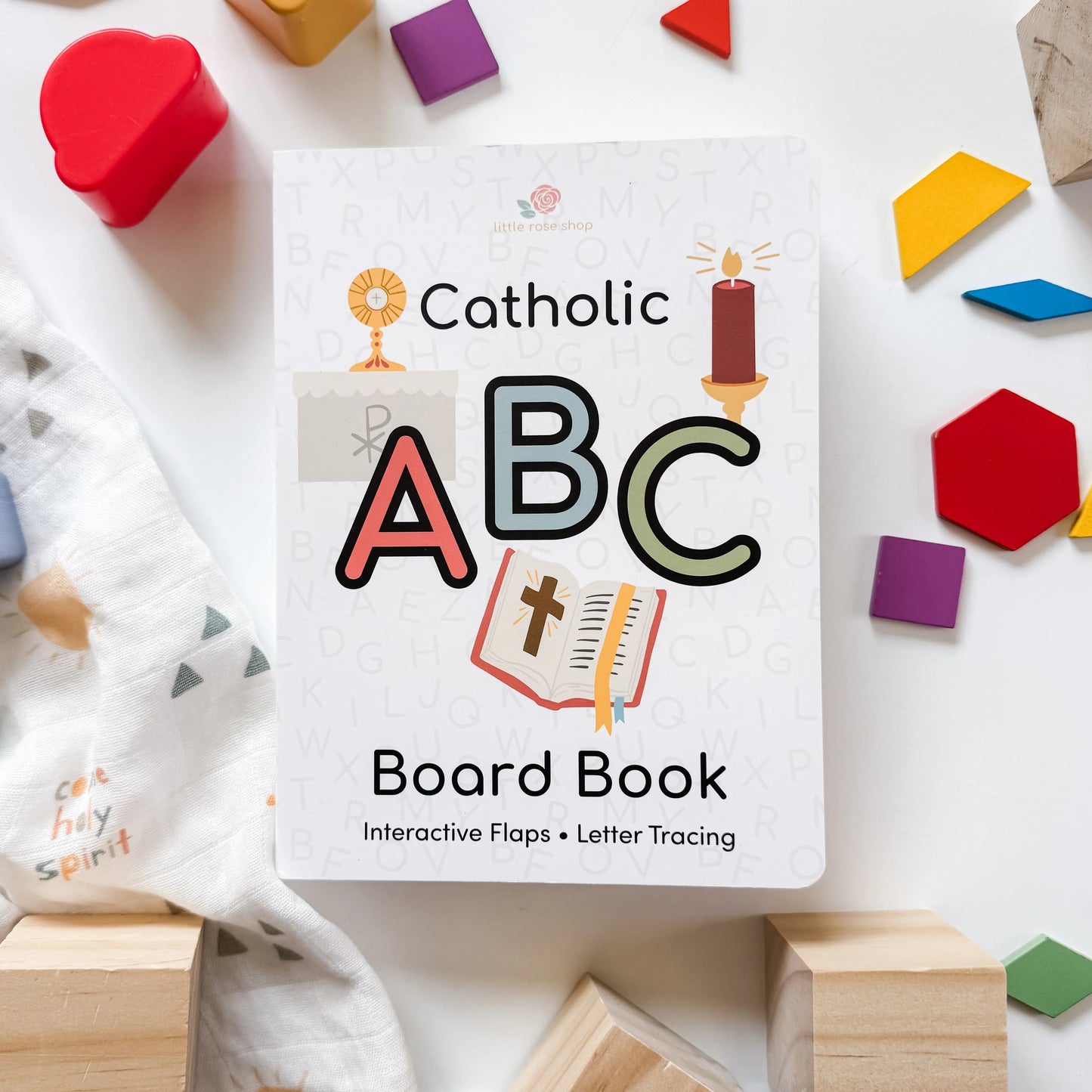 Catholic ABC board book for children featuring interactive flaps, letter tracing, and faith-based illustrations on white background