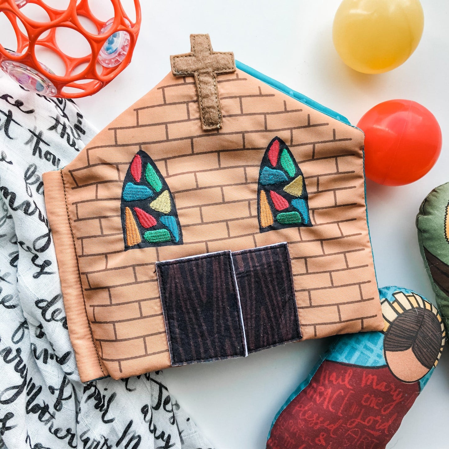 Soft fabric Catholic church quiet book page with stained glass windows, cross, and wooden doors for toddlers