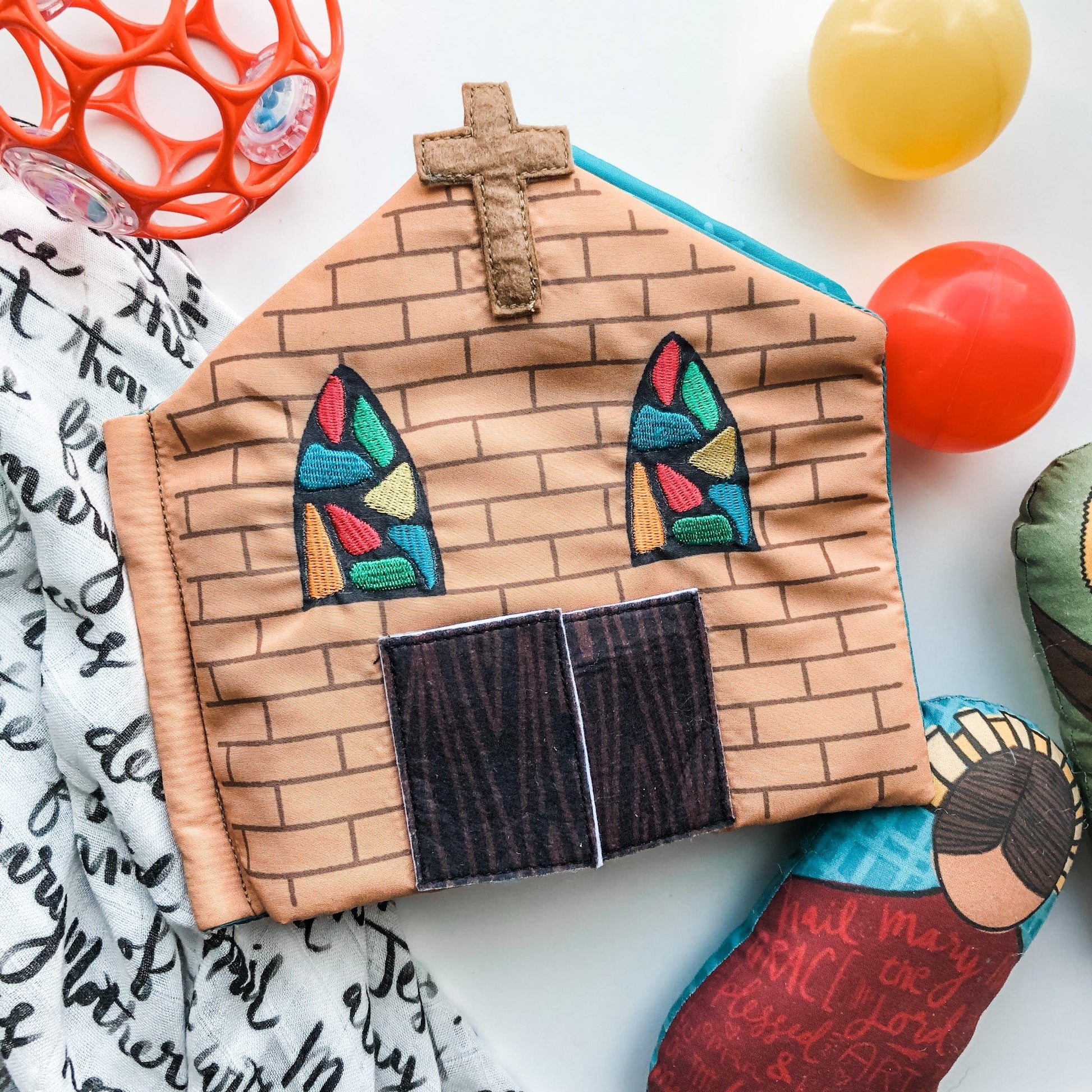 Soft fabric Catholic church quiet book page with stained glass windows, cross, and wooden doors for toddlers