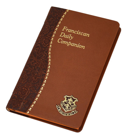 Franciscan Daily Companion book with brown cover, gold embossed title and ornate emblem on front, devotional spiritual journal