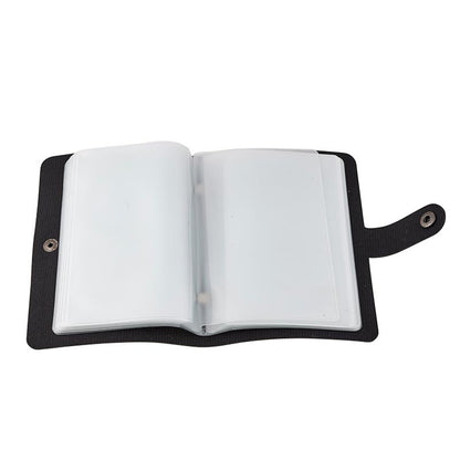 Black holy card wallet open showing clear plastic sleeves and durable faux leather cover with snap closure