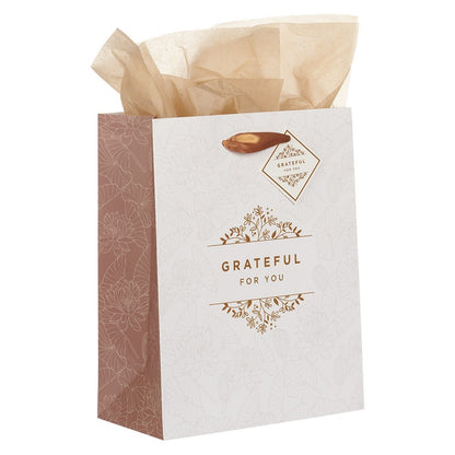 Medium white and gold gift bag with floral design, copper handles, "Grateful For You" text, and tissue paper inside