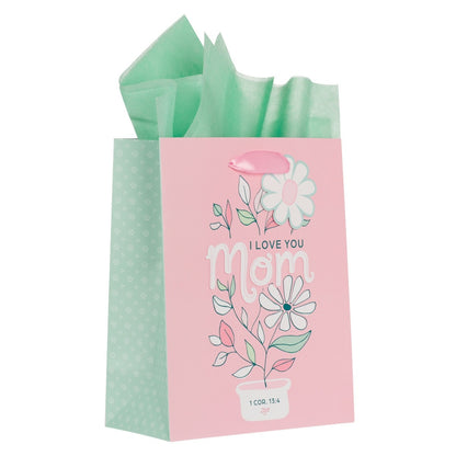 Medium pink gift bag with white daisies, green leaves, "I Love You Mom" text, and 1 Corinthians 13:4 bible verse design