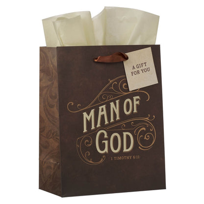 Medium brown gift bag with "Man of God 1 Timothy 6:11" text and decorative swirls, including a gift tag and tissue paper