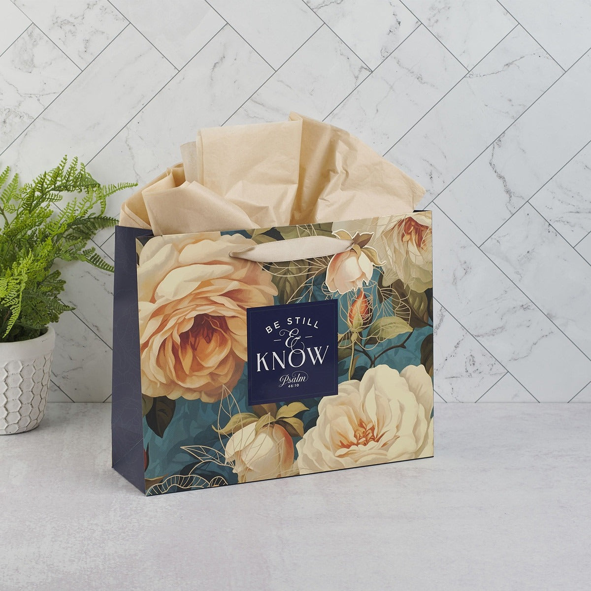 Large landscape gift bag with serene roses design, navy side panels, and "Be Still & Know Psalm 46:10" scripture text