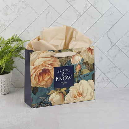 Large landscape gift bag with serene roses design, navy side panels, and "Be Still & Know Psalm 46:10" scripture text