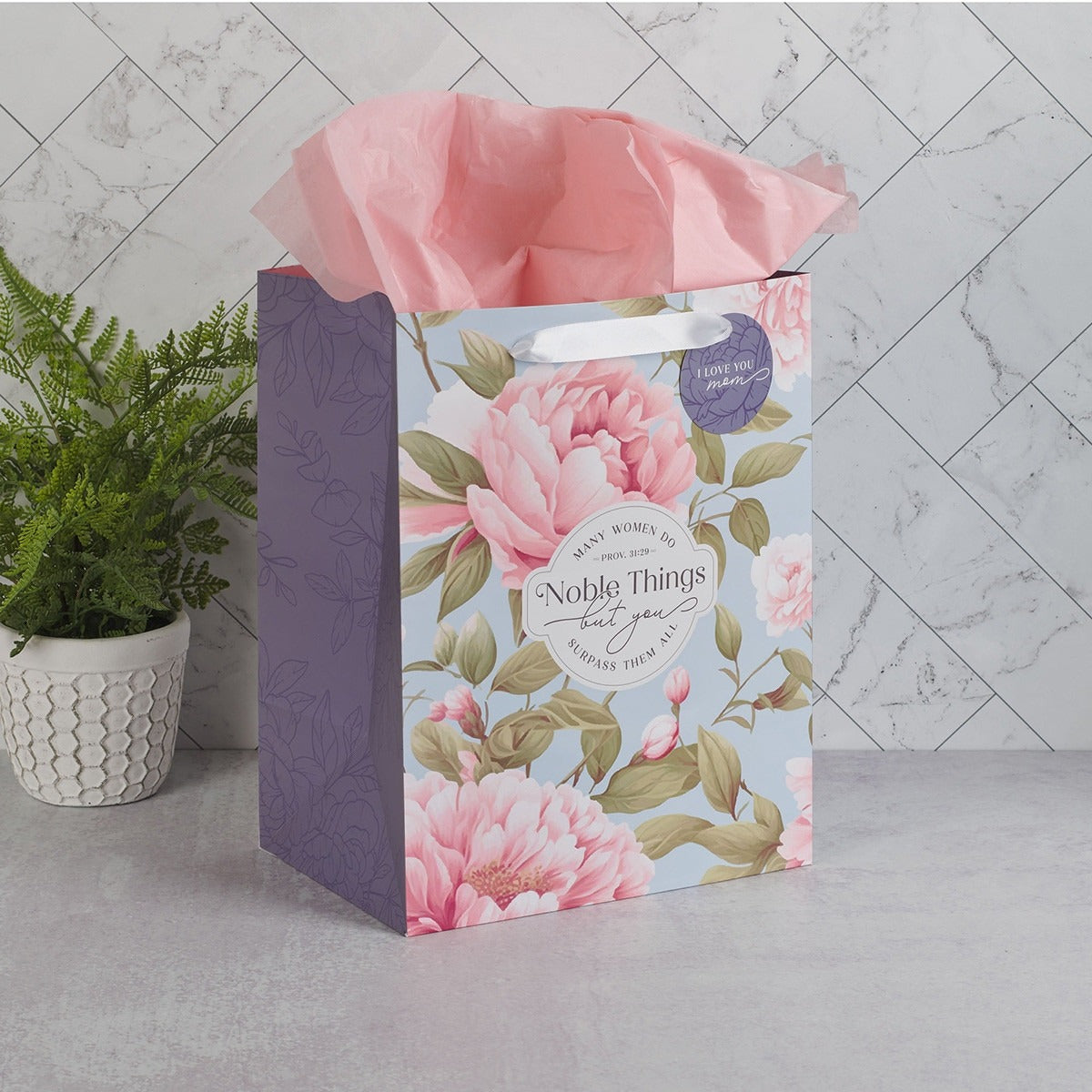 Large portrait gift bag with pink peony floral design, Proverbs 31:29 sentiment, and pink tissue paper inside