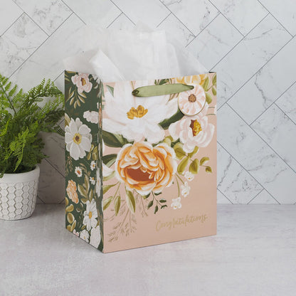Large peach floral portrait gift bag with green handles, white tissue paper, and "Congratulations" script text