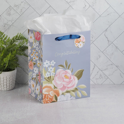 Large portrait gift bag with blue background, pink and white floral design, ribbon handles, and "Congratulations" text