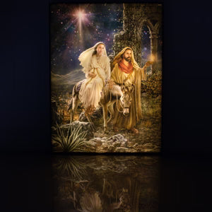 Illuminated canvas print of the nativity scene "Journey to Bethlehem" featuring Mary and Joseph with starry night background