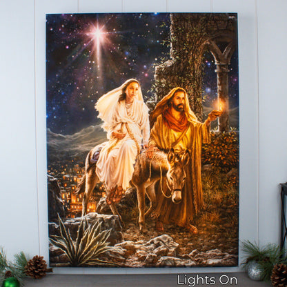 Illuminated canvas print of Mary and Joseph’s journey to Bethlehem with bright star and warm glowing light