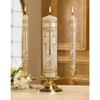 Wedding unity candle set with gold cross and rings on white wax with gold leaf accents on brass holder