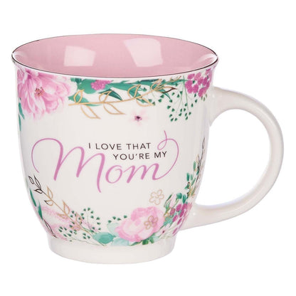 Ceramic coffee mug with pink interior, floral design, and the phrase "I Love That You’re My Mom" in elegant script